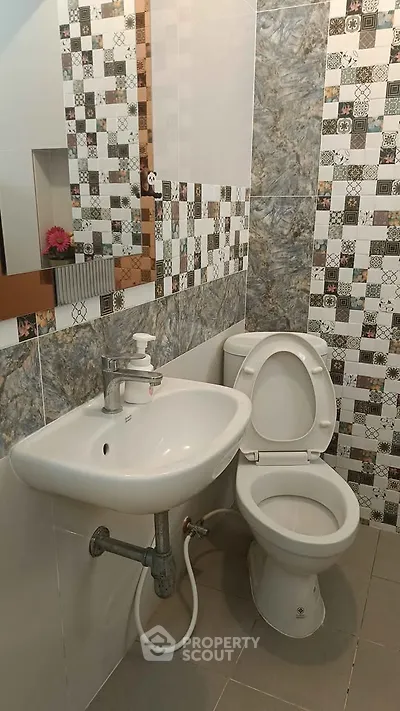 Modern bathroom with stylish tile design and compact fixtures