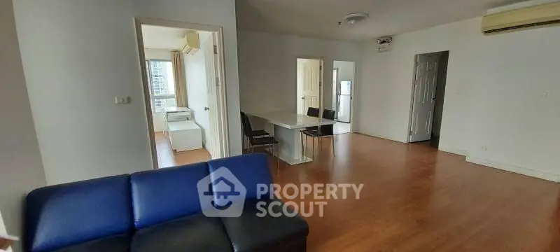 Spacious open-plan living area with modern furnishings and natural light.