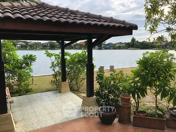 Charming lakeside gazebo with lush greenery and serene water views