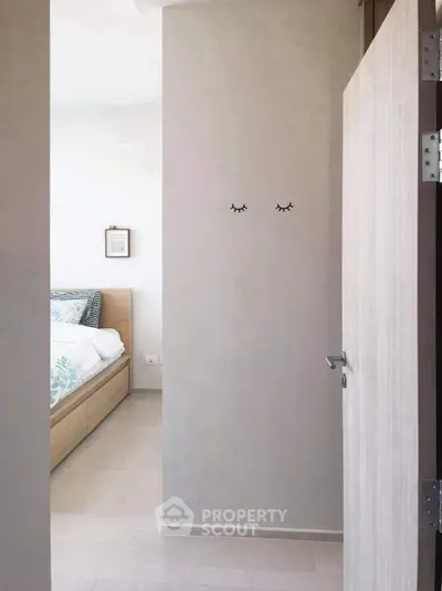 Cozy bedroom entrance with stylish decor and modern wooden bed frame.