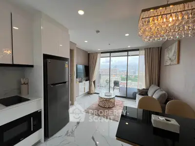 Modern open-plan living room with city view, elegant decor, and sleek kitchen appliances.