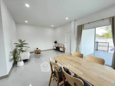 Spacious modern living room with dining area and balcony access