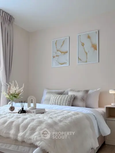 Elegant bedroom with plush bedding and stylish decor, featuring soft lighting and modern artwork.
