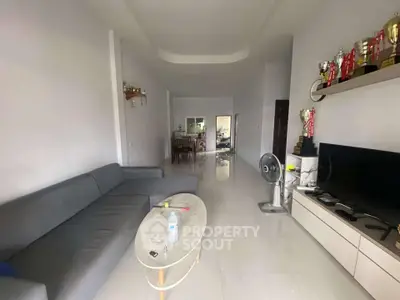 Spacious living room with modern decor and sleek furniture, perfect for family gatherings.