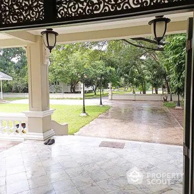 Elegant entrance with marble flooring and lush garden view in luxury property