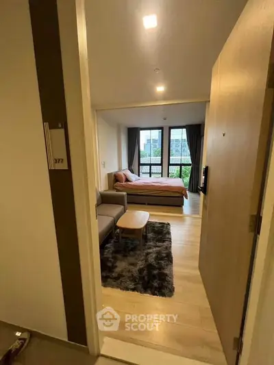 Modern bedroom with cozy seating area and large window view