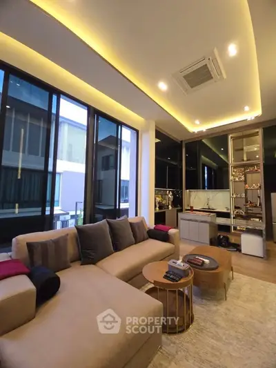 Luxurious modern living room with elegant furniture and ambient lighting, featuring large windows and stylish decor.