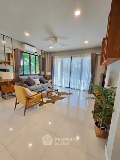 Spacious modern living room with large windows and stylish decor