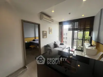 Modern apartment living room with open kitchen and balcony view