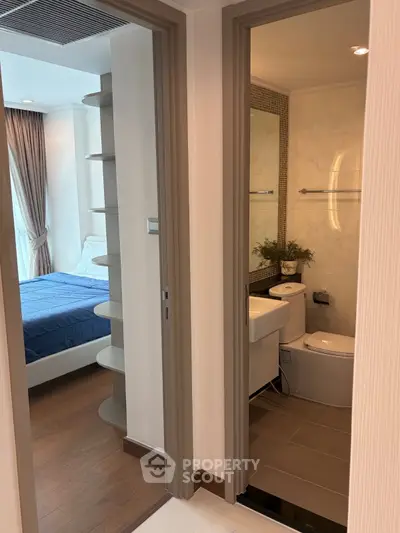 Modern apartment interior featuring a cozy bedroom and sleek bathroom with contemporary design.