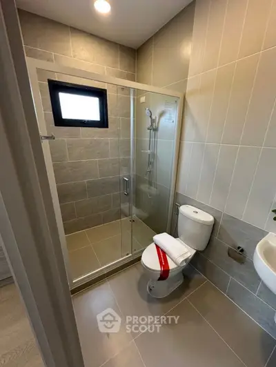 Modern bathroom with glass shower and sleek tile design