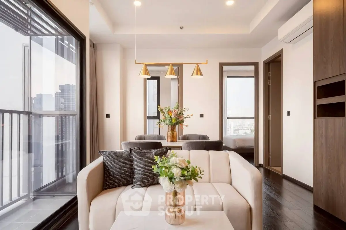 Modern living room with elegant decor and city view balcony access.