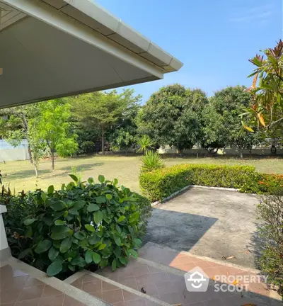 Charming garden view from a suburban home with lush greenery and spacious yard.