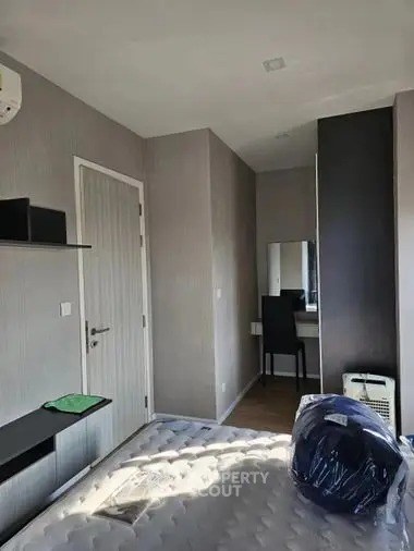 Cozy bedroom with natural light, modern furnishings, and a glimpse into the adjoining study area, perfect for rest and productivity.