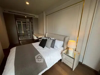 Luxurious bedroom with elegant decor and modern furnishings, featuring a cozy bed and stylish lighting.