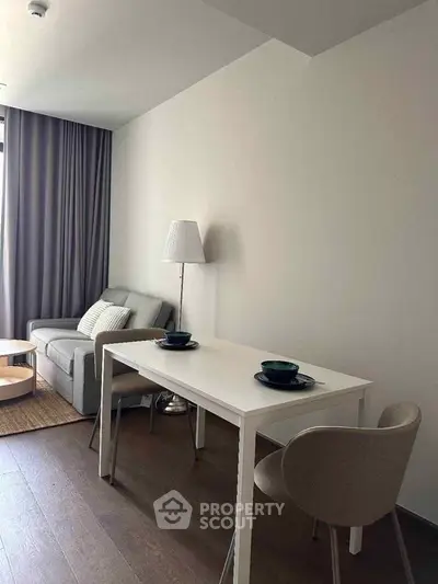 Modern living room with cozy sofa and dining area in stylish apartment