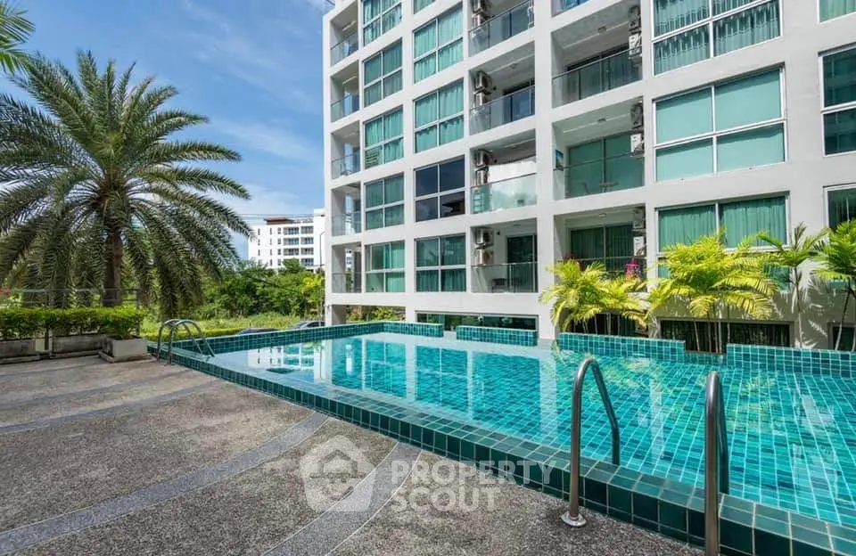 Luxurious condominium with stunning pool and lush greenery, perfect for modern living.