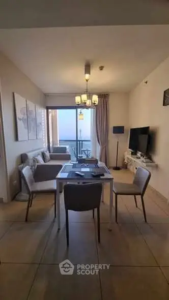 Modern living room with dining area and balcony view, elegant decor and natural light.