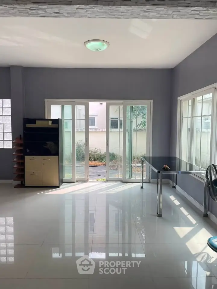 Spacious living room with large windows and modern decor