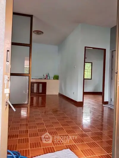 Spacious interior with tiled flooring and a small kitchenette, perfect for cozy living.