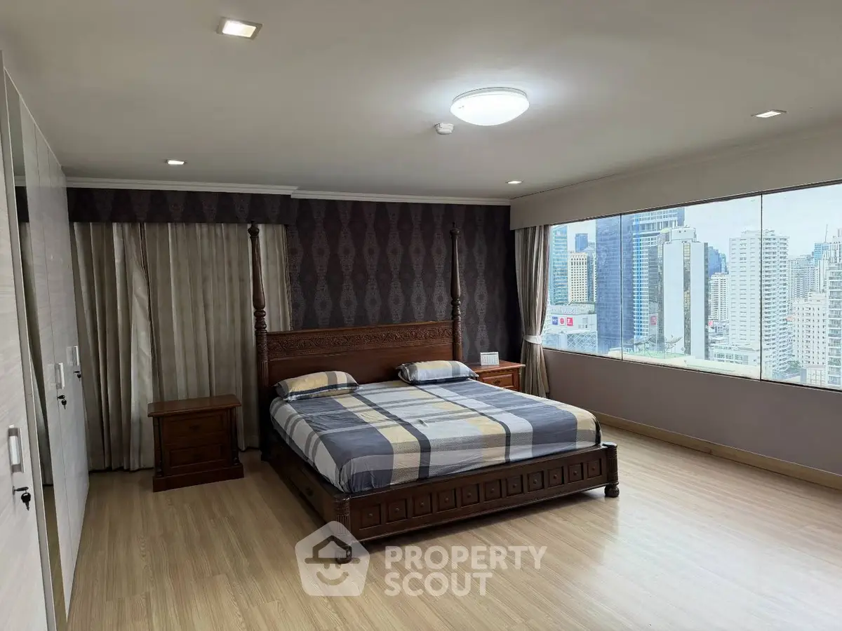 Spacious bedroom with city view and elegant wooden furniture