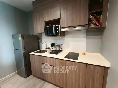 Modern kitchen with sleek wooden cabinets and stainless steel appliances