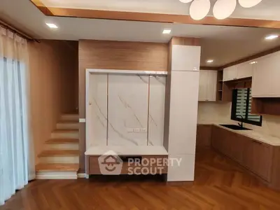 Modern kitchen with wood flooring and sleek cabinetry