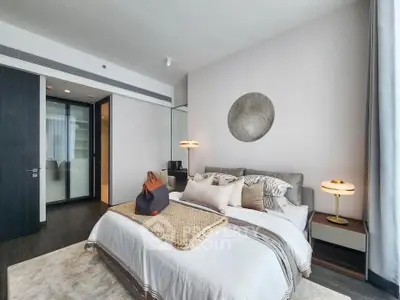 Luxurious modern bedroom with elegant decor and plush bedding in a high-end apartment.