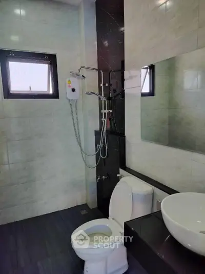 Modern bathroom with sleek fixtures and large mirror in contemporary home