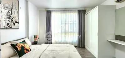 Bright and modern bedroom with stylish decor and ample natural light.