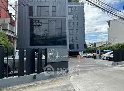 Modern urban building with parking area and sleek architectural design