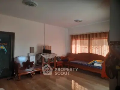 Spacious living room with wooden flooring and cozy seating area