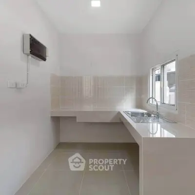 Modern minimalist kitchen with sleek countertops and natural light