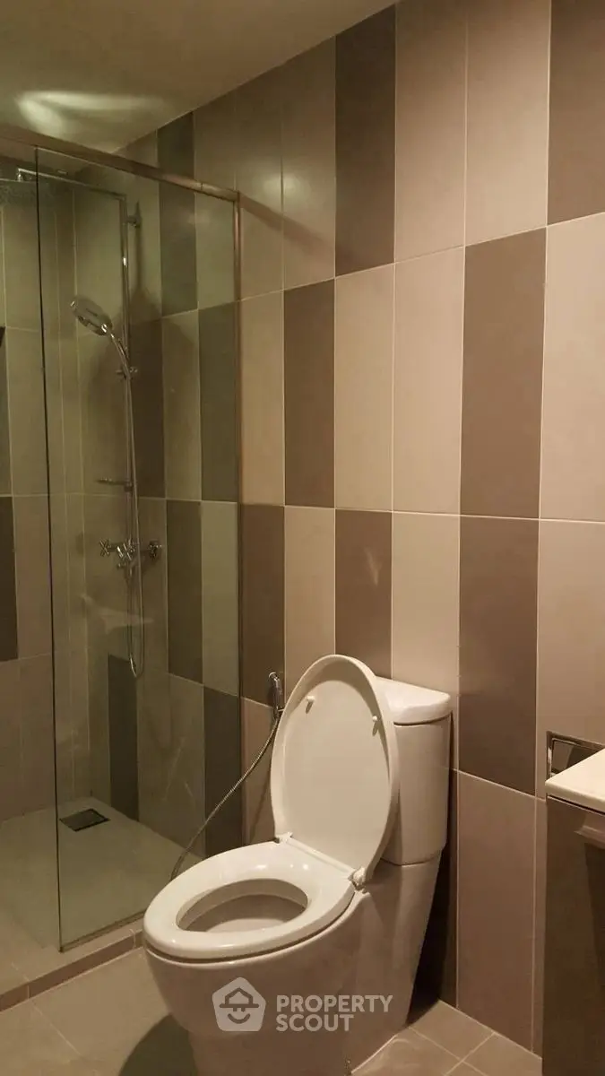 Modern bathroom with sleek tile design and glass shower enclosure