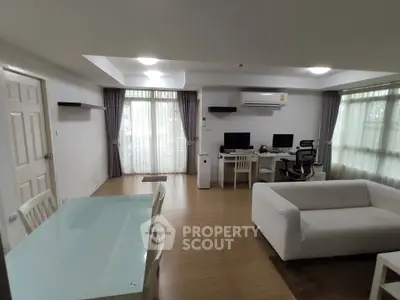 Spacious modern living room with dining area and home office setup
