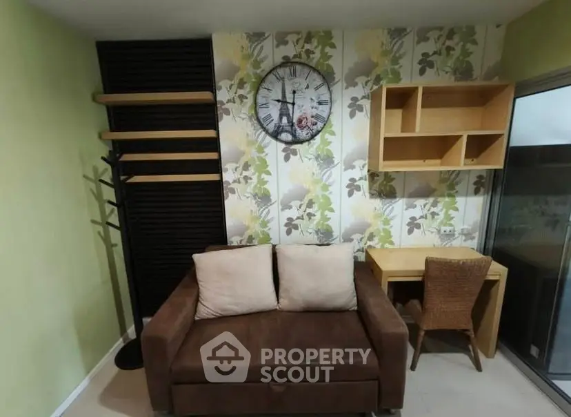 Cozy living room with stylish decor, featuring a brown sofa, wall clock, and wooden shelves.