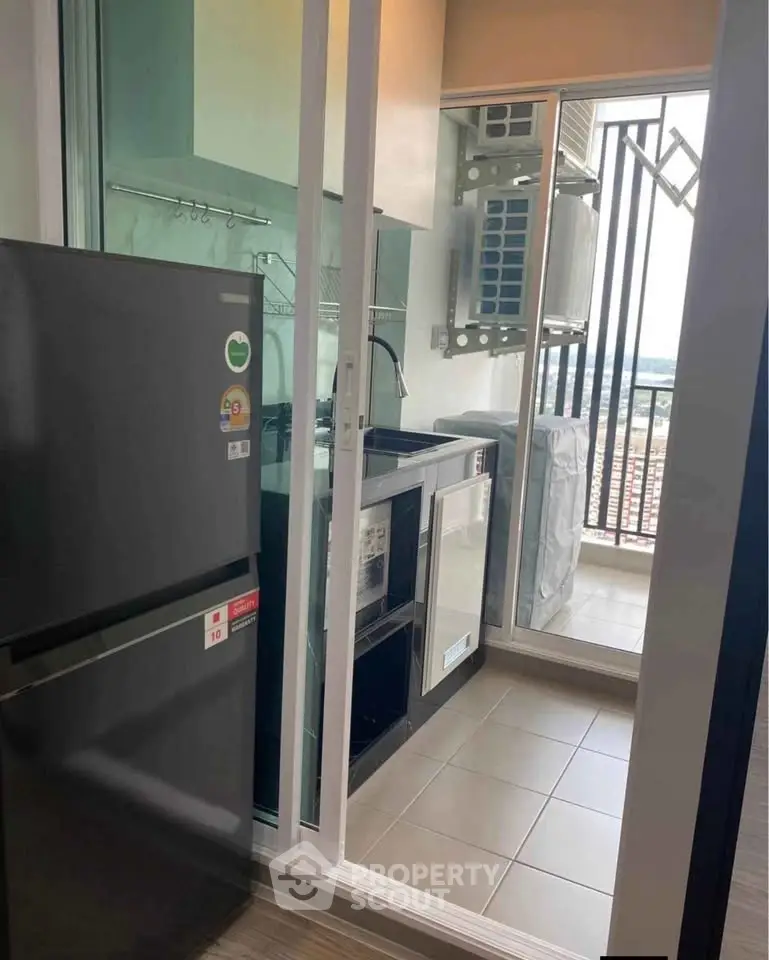 Modern kitchen with sleek appliances and balcony view, perfect for urban living.