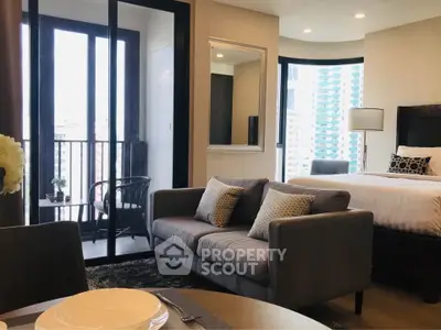 Modern studio apartment with stylish decor and city view balcony.