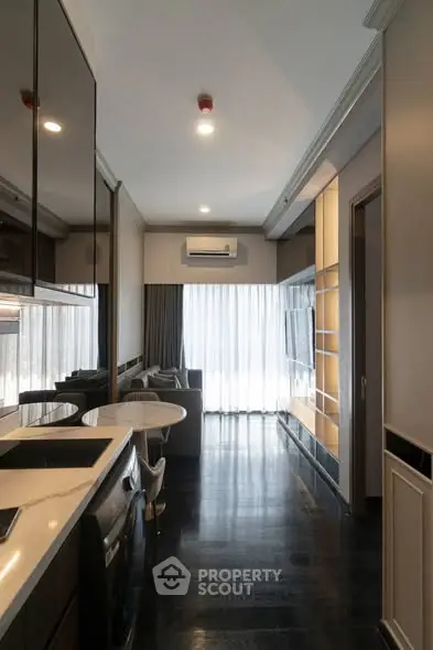Modern apartment interior with sleek kitchen and cozy living area, featuring floor-to-ceiling windows and stylish decor.
