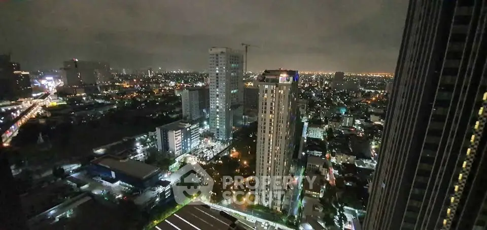 Stunning cityscape view from high-rise building at night with illuminated skyline.