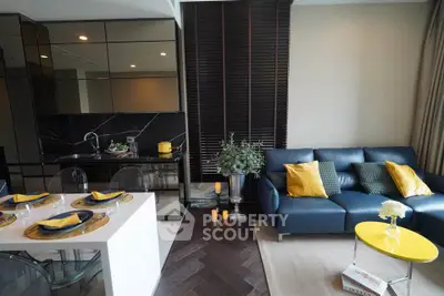 Modern living room with open kitchen, stylish decor, and cozy seating area in a contemporary apartment.