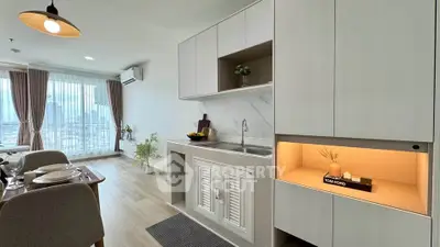 Modern open-plan kitchen and dining area with elegant decor and natural light.