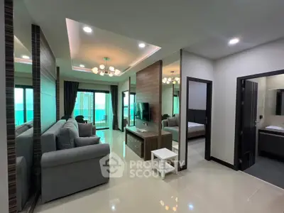 Modern living room with stylish decor and open layout, featuring a cozy seating area and elegant lighting.