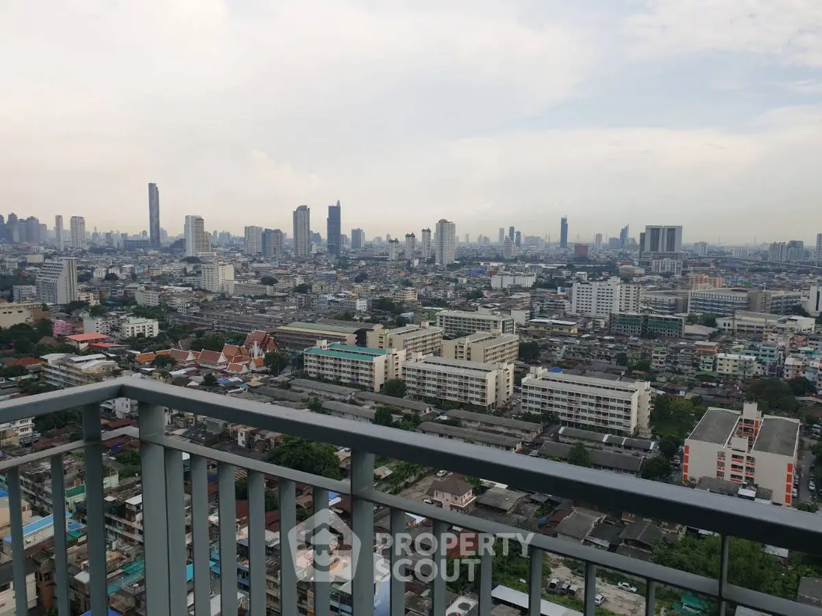 Stunning cityscape view from high-rise balcony overlooking urban skyline.