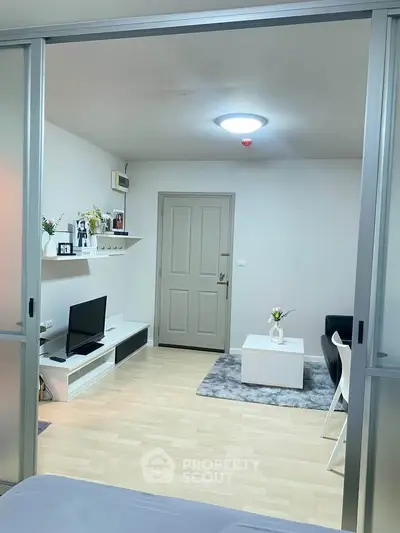 Modern living room with sleek design and cozy atmosphere, featuring stylish furniture and decor.