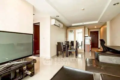 Spacious modern living room with sleek furniture and dining area in open layout apartment.
