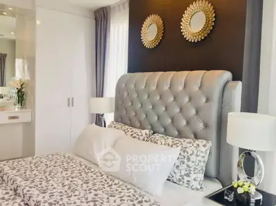 Luxurious bedroom with elegant decor and plush bedding in modern apartment.