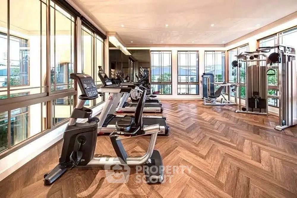 Luxurious gym with modern equipment and stunning views in a high-end residential building.