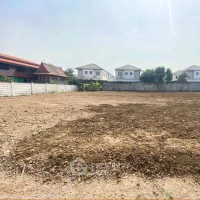 Spacious empty plot of land ready for development in a residential neighborhood.