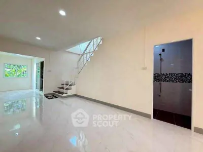 Spacious modern interior with staircase and tiled flooring, perfect for stylish living.